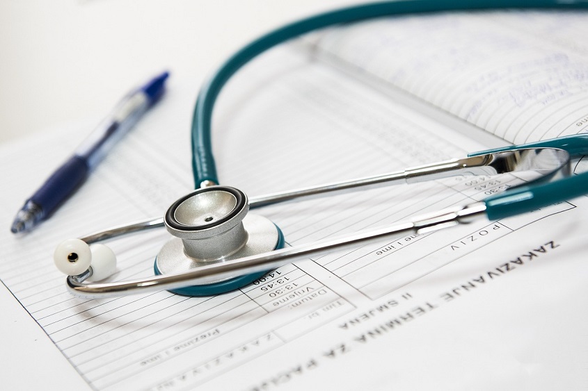 Doctor using electronic health record (EHR) system for patient maintenance