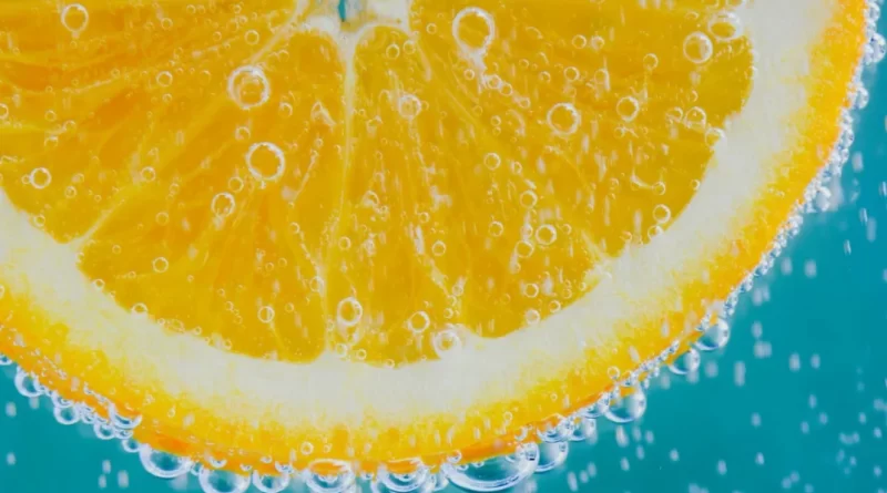 Close-up of juicy fruit slice with water droplets glistening on the surface